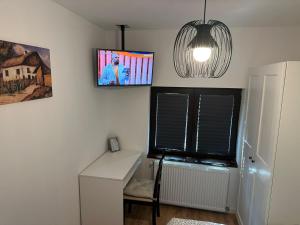 a room with a desk and a window and a lamp at Tiny Traditional House in Bucharest