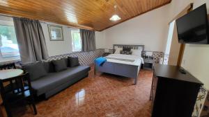 a living room with a couch and a bed at Guesthouse of Alcobaça in Alcobaça