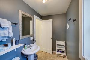 a blue bathroom with a sink and a mirror at Elkhart Lake Vacation Rental 3 Mi to Road America! in Elkhart Lake +17 photos