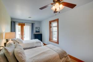 a bedroom with two beds and a ceiling fan at Elkhart Lake Vacation Rental 3 Mi to Road America! in Elkhart Lake