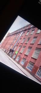 a tall red brick building with lots of windows at Leicester City centre en suite budget room for 1 in 2 bed apartment in Leicester