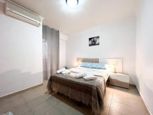 a bedroom with a bed with two pillows on it at Apartamento en Torrevieja in Torrevieja