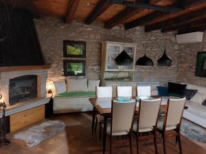 a living room with a table and chairs and a fireplace at Villa Viktor in Labin