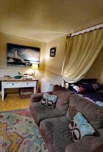 a living room with a couch and a table at Studio in the heart of Kirkwall in Orkney