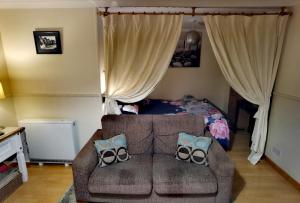 a living room with a couch and a bed at Studio in the heart of Kirkwall in Orkney