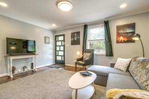 uma sala de estar com um sofá e uma televisão em Freshly Renovated Raleigh Home Near Downtown! em Raleigh