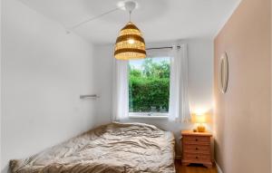 a bedroom with a bed and a window at 3 Bedroom Awesome Home In Vejby in Vejby