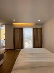 a bedroom with a large bed and a large window at Apartments Basha 1 - Long Beach in Ulcinj