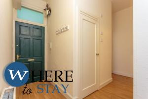 a room with a green door with the words where to stay at Delightful 2 bedroom apartment in Leith in Edinburgh