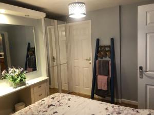 a bedroom with a bed and a large mirror at Turnstone in Seaton