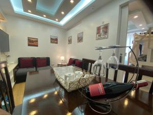 a living room with a table with a bottle of wine at MidKnight Sky Unit for Rent in Anabu Primero