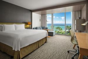 a hotel room with a bed and a view of the ocean at Beach Club at The Boca Raton in Boca Raton