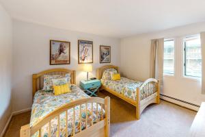 a bedroom with two beds and a window at Snowmass Village 14A in Snowmass Village +42 photos