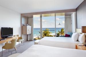 a hotel room with two beds and a view of the ocean at Beach Club at The Boca Raton in Boca Raton