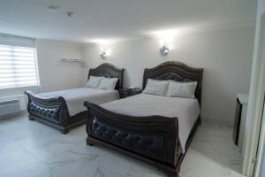 um quarto com 2 camas e uma janela em Diplomat Inn em Cataratas do Niágara