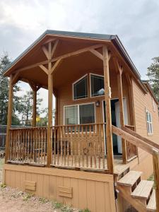 a screened in porch on a house with a deck at Cedar Tiny Home in Woodland Park
