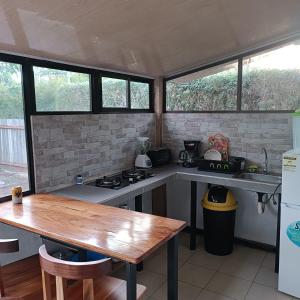 a kitchen with a stove and a table in it at Casa Bambu in Pavones