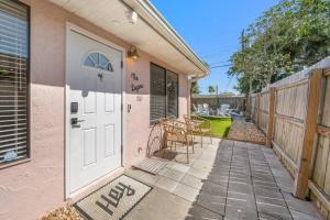 a pink house with a white door and a patio at Luxury Beach House Oasis 3 Blocks from the Beach in Cape Canaveral