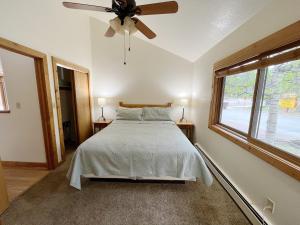 a bedroom with a bed and a ceiling fan at Cabin Suite in Woodland Park