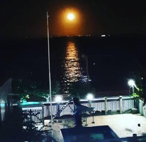 a view of the ocean at night with the moon at Varandas Lagoa Azul in Araruama