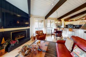 a living room with a couch and a fireplace at Peaceful Woodbridge Hideaway in Snowmass Village
