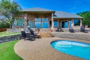 a house with a patio and a swimming pool at Lakefront Little Elm Home with Private Pool! in Little Elm
