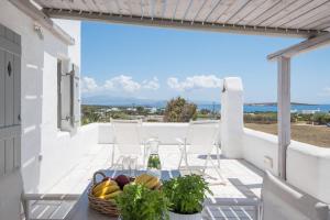 a table with a basket of fruit on a balcony at Aeraki Villas in Santa Maria