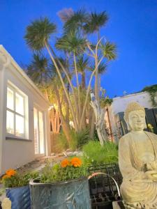 a statue of a buddha in front of a house at The Ferry Boat in Portmagee