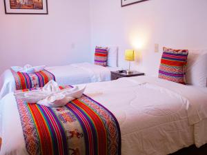 Cama ou camas em um quarto em Hotel Santa Maria