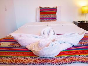 Cama ou camas em um quarto em Hotel Santa Maria