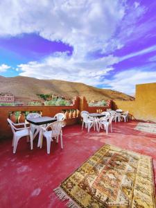 a group of tables and chairs on a patio at Auberge NICE VIEW DADES in Akhendachou nʼAït Ouffi