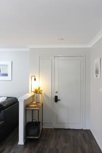 a white door in a living room with a table at Yamba Twin Pines Motel in Yamba