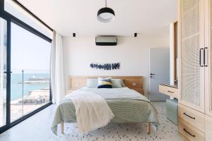 a bedroom with a bed with a view of the ocean at Designer Seaview Condo in Gleem in Alexandria