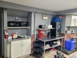 a kitchen with white cabinets and a counter with appliances at Banff International Hostel in Banff