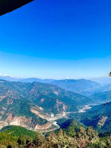 an aerial view of a valley with mountains and forests at Aroma Homestay in Kalimpong