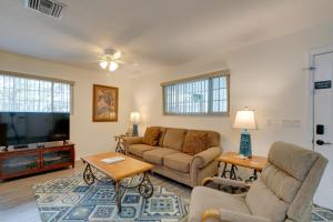 a living room with a couch and a tv at Homosassa Home with Pool Access - By Boat Launch in Homosassa