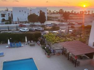 a view of a parking lot with a pool at Georgia Apartments in Paphos