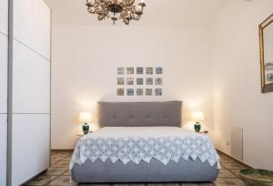 a bedroom with a bed and two lamps at Bellavista apartment in Caltagirone