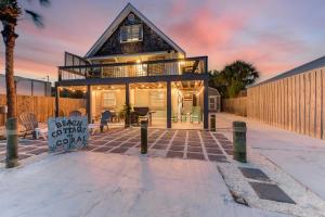 a house with a deck and a patio at PCB Group Retreat with Deck, 1 Block to Beach! in Panama City Beach
