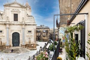 a view of a building in a street with flowers at Bellavista apartment in Caltagirone