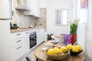 a kitchen with a table with a bowl of lemons on it at Bellavista apartment in Caltagirone
