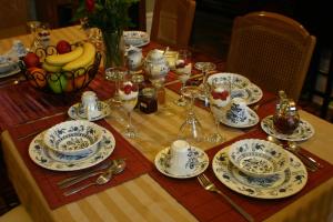 a table with a table set with plates and dishes at Gingerbread Manor in Montreal