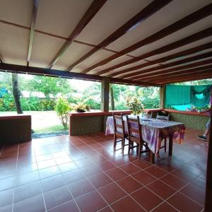 a dining room with a table and chairs on a patio at IL Delfino in Pavones