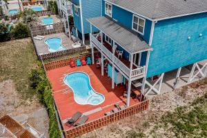 an aerial view of a blue house with a swimming pool at Escape to Ocean Isle in Ocean Isle Beach