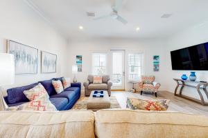 sala de estar con sofá azul y TV en Lost Dunes #N- Seashore, en Gulf Shores