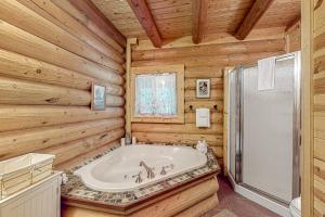 a log cabin bathroom with a tub and a shower at Misty Mountain Lodge in Tillamook +22 photos