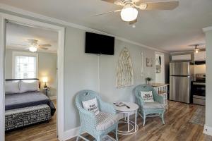a bedroom with a bed and two chairs and a table at Pura Vida - B -Murrells Inlet in Myrtle Beach