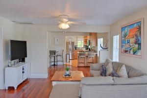 a living room with a couch and a flat screen tv at Longboard in Holmes Beach