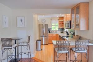 a kitchen with a table and chairs and a refrigerator at Longboard in Holmes Beach