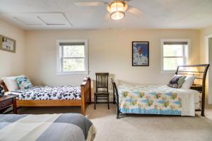 a bedroom with two beds and a ceiling fan at Vermont Vacation Rental Hot Tub, Near Ski Resorts in Mount Holly
